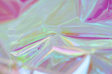 Iridescent plastic wrap abstract background with vibrant colors and soft glowing light