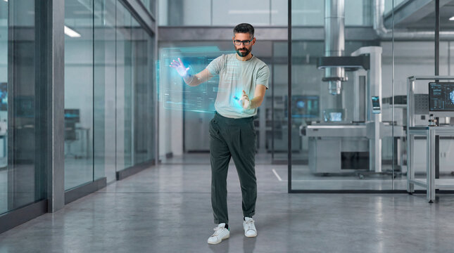 Technology engineer interacting with holographic interface inside advanced research laboratory
