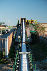 Fototapeta premium Industrial Conveyor Transporting White Granular Material