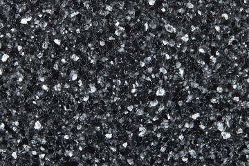 A close-up view of black granite, exhibiting its intricate patterns and textures, a perfect backdrop