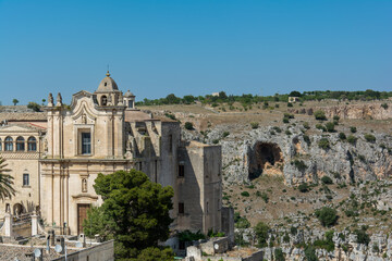 Fototapeta premium Historic stone church overlooking rocky canyon landscape under clear blue sky