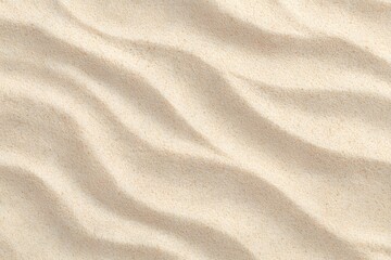 Fototapeta premium Close-up view of pristine, wavy sand on the beach with a warm color tone. The sand texture creates a natural, aesthetic pattern.