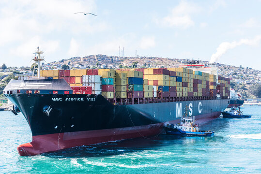 Massive MSC container ship transitioning from harbor waters to the open sea near San Antonio, highlighting efficiency in global shipping operations.