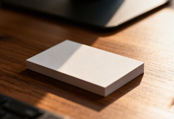 realistic business card mockup on wooden desk with soft natural lighting, minimal name card branding mockup with subtle shadow on wood texture, professional business card presentation close up