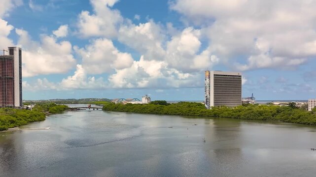 Stunning 4K drone view of Recife's giant mural on a tall modern building: smiling man with crown, vibrant colors, piano keys, ocean skyline backdrop. (138 characters)