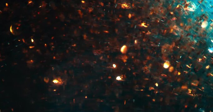 Slow Motion Of Golden Particles Illuminating In Liquid. Abstract Scientific Fluid Motion
