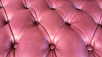 Fototapeta premium Close-up of pink button tufted leather upholstery, close up