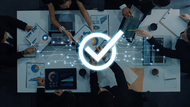 A dynamic business meeting showcases professionals engaging in data analysis with laptops and charts while a digital network graphic emphasizes collaboration and strategy. Trope