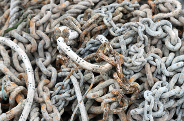 Tangled rusty metal chains and marine rope texture