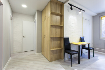 Fototapeta premium A well-lit, modern apartment interior is shown in the image.