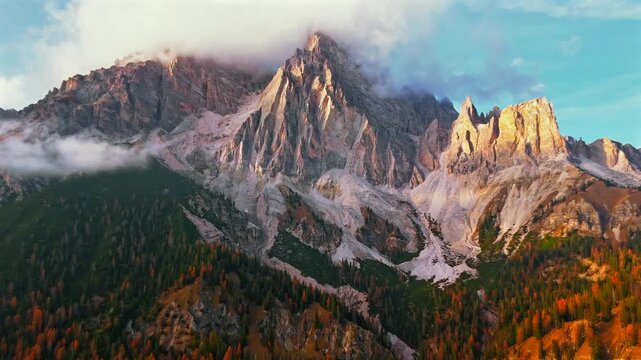 Aerial hyperlapse of high mountain peak with clouds in Dolomites, Italy