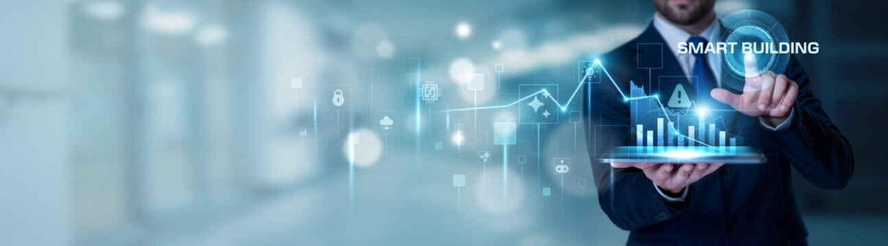 Businessman using the tablet analysis Smart Building and intelligent infrastructure concept, IoT systems, energy efficiency, automated facilities, sustainable architecture, digital building management