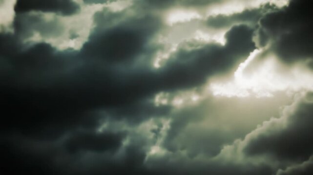 Heavenly rays pierce a dramatic stormy sky, casting glowing light through clouds to evoke hope, spiritual renewal, and a path toward peace and salvation amidst turmoil