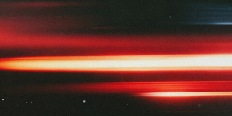 A blurred abstract image showcasing vibrant red and white light streaks against a dark backdrop © Nasrin