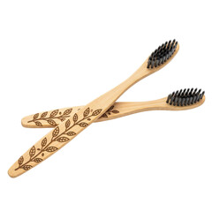 Two bamboo toothbrushes with engraved leaf pattern on transparent