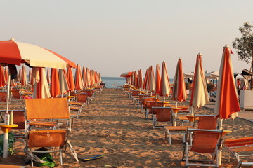 Summer Beach Scene in Bibione Italy with Orange Umbrellas