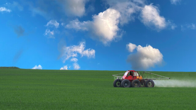 A panoramic aerial view of a field of green crops, where a self-propelled sprayer is working. The field is being treated with herbicide, fungicide, pesticide, or fertilizer in spring.