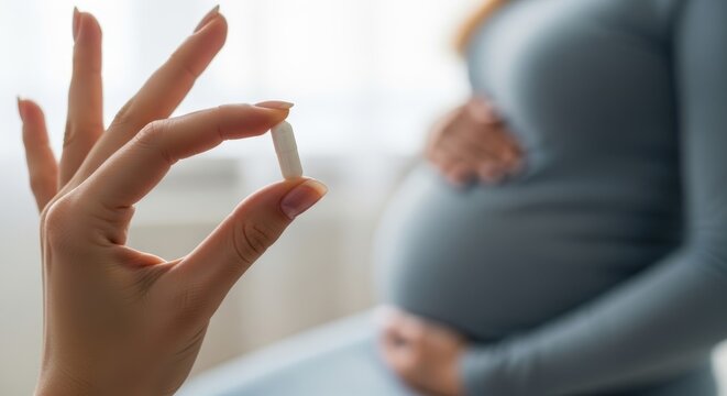 Blurred silhouette of a pregnant lady and a sharp focus on a medicine capsule, suitable for pharmacy and healthcare advertisements.