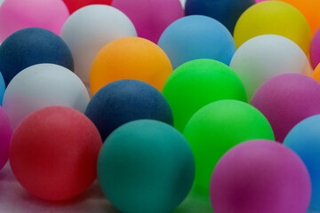 Fototapeta premium Colorful balls arranged closely together on a flat surface with various colors in the background during daylight
