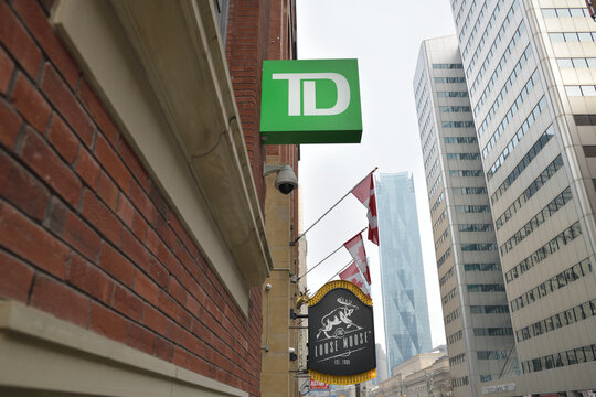 projecting square corporate logo sign of TD (Toronto Dominion Group) at 160 Front St W, incl Loose Moose / Antler Room sign, CIBC Square and Citigroup Place (looking east)