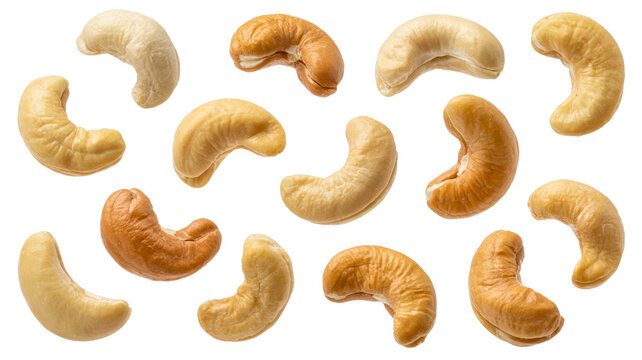 Roasted cashews in various shades of golden brown floating against transparent background