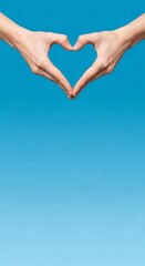 Obraz premium Woman forming heart shape with her hands against blue background. Gesture of love and support for Valentines Day. Romantic express for greeting card.