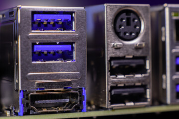 Close view of computer ports showing USB and audio connections on a circuit board near a power source