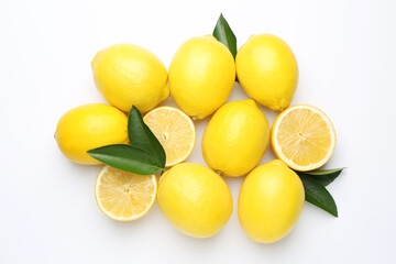 Fresh yellow lemons and green leaves on white background, flat lay