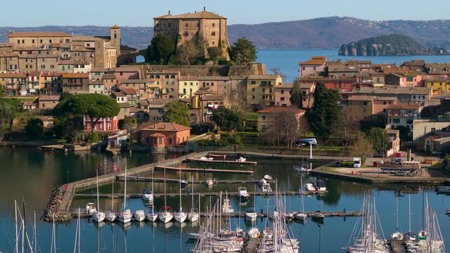 Capodimonte Village and Farnese Castle Aerial Reveal. Lake Bolsena Italy Marina and Sailing Boats. Mediterranean Aesthetics Cinematic Drone Flight and Harbor View 4K 10-bit