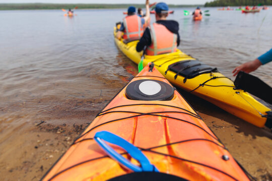 Kayaking in the lake, colorful canoe kayak boat paddling, canoeing in river, scandinavian skerries landscape, group of tourists athletes in kayaks floating, kayakers rowing during water sports tour