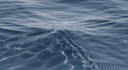 Serene rippling water with subtle reflections and gentle waves in soft blue hues creating a calming natural background