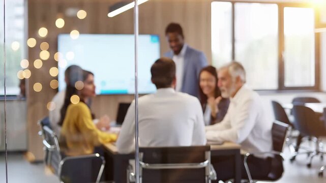 Diverse business team in a conference room during a corporate presentation and group discussion. Collaborative workplace meeting and leadership strategy session. Professional teamwork inclusive office