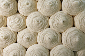 Merino wool yarn rolls texture background for textile manufacturing industry © st.kolesnikov