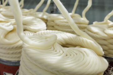 Merino wool yarn winding on industrial spinning production line © st.kolesnikov