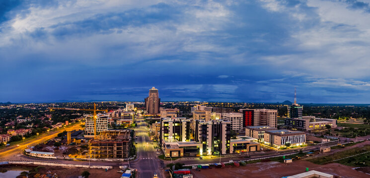 Gaborone Central Business District construction at dusk with city skyline and industrial machinery, Botswana.