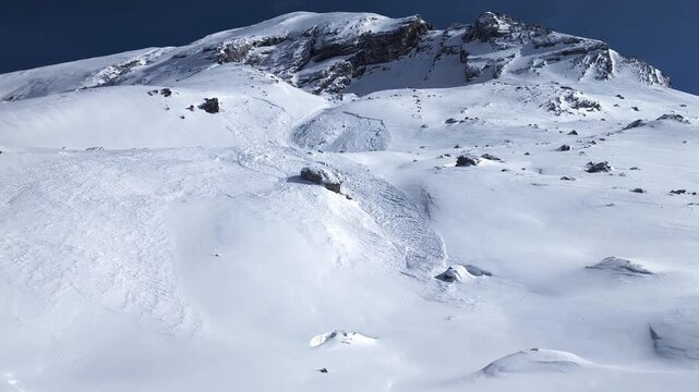 Avalance aftermath on a snow covered mountain slope, danger establisher 