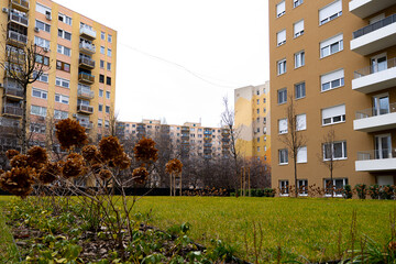 Urban Residential Apartment Buildings with Green Courtyard Lawn in Foreground. Modern apartment buildings surrounding a landscaped green courtyard in an urban residential neighborhood. © Nagy