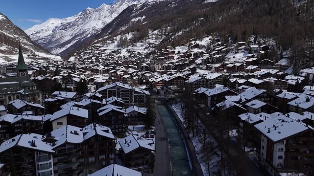 Winter Landscape of Zermatt with Snowy Rooftops and Flowing River