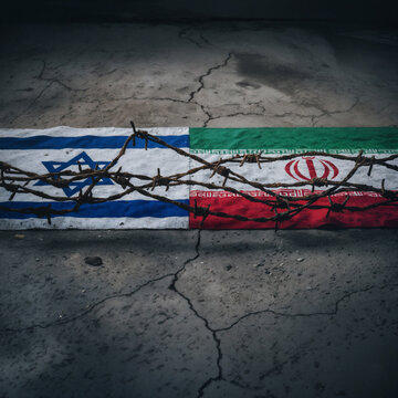 flags of israel and iran on cracked concrete separated by rusty barbed wire symbolizing conflict