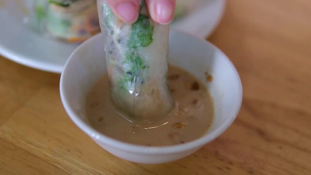 fresh spring rolls dipped in peanut sauce savory soy sauce enhances its rich umami flavor. balanced combination of fresh vegetables and soy sauce creates a light, healthy and authentic Asian taste.