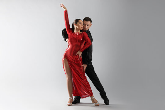 Couple of professional dancers on grey background