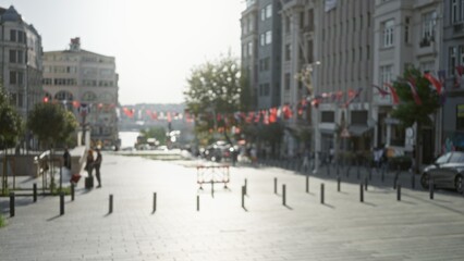 City street blurred bokeh background with sunlit flags, distant waterfront and soft architectural facades; backdrop copyspace backplate calm.