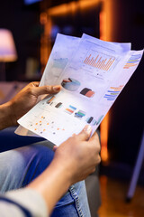 African american freelancer does his research by reading articles and data driven papers in the...