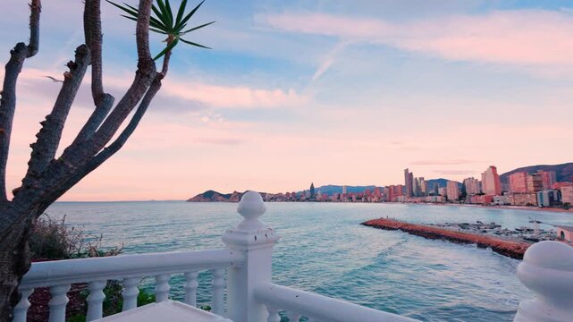 Scenic view of benidorm city skyline from a balcony at sunset