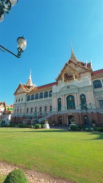 A majestic view of the Ananta Samakhom Throne Hall in Bangkok, Thailand, showcasing its grand architecture and lush green surroundings