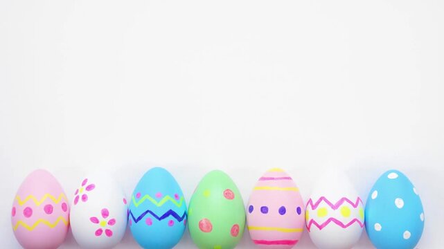 Colorful Easter Egg bottom border on a white background. Stop motion. Copy space.