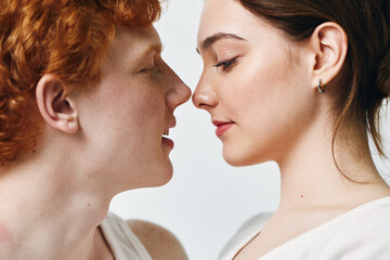 Fototapeta premium Couple, man and woman close together looking into each other's eyes for romance and love. Portrait with intimate and gentle expression, connection, relationship, affection at home.