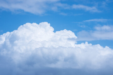 A large white cloud against a blue sky.