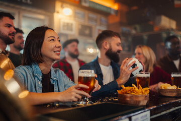 Friends watching sports game in a lively bar with beer