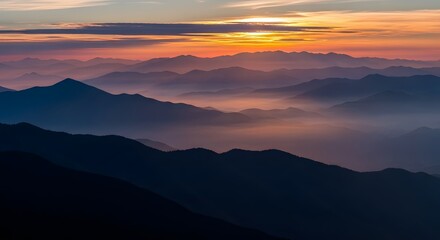 Fototapeta premium Serene mountain range at sunset with soft mist and warm light filtering through the peaks, creating a breathtaking natural landscape